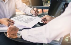 Men signing a contract